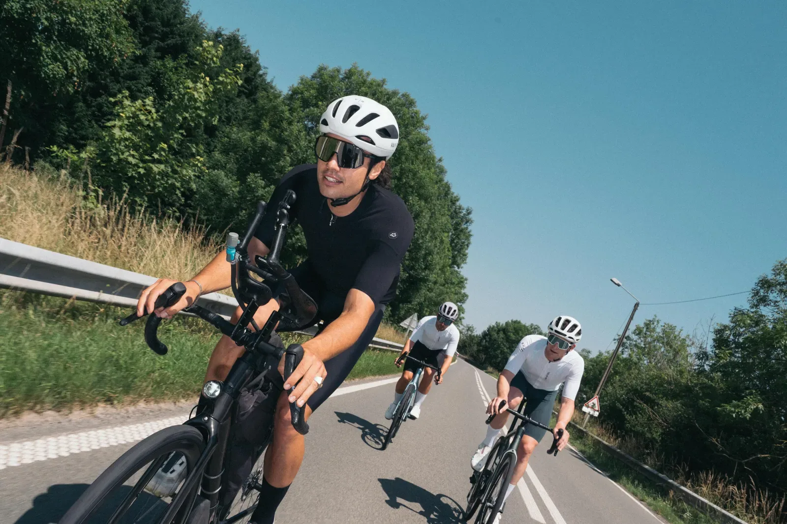 Group of road cyclists riding a country road