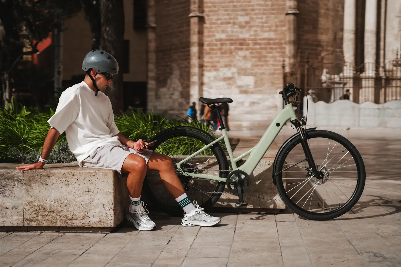 Man resting beside a step-through city bike