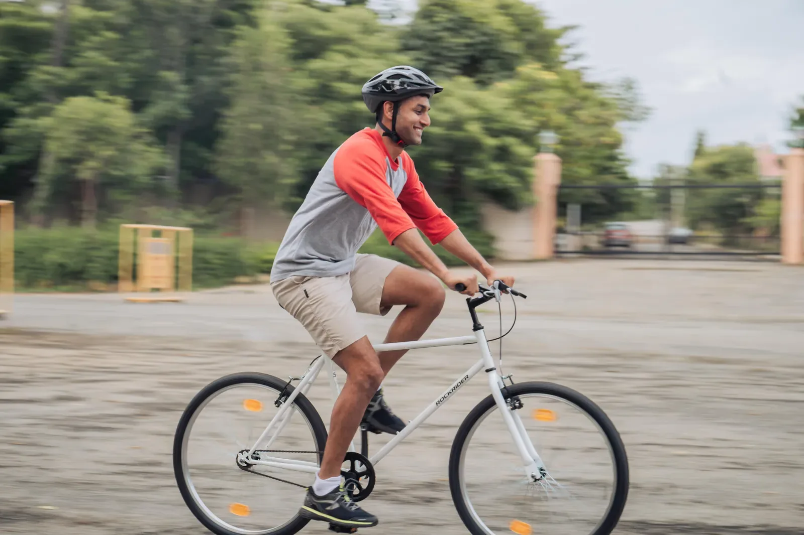 Man riding a white hybrid bike