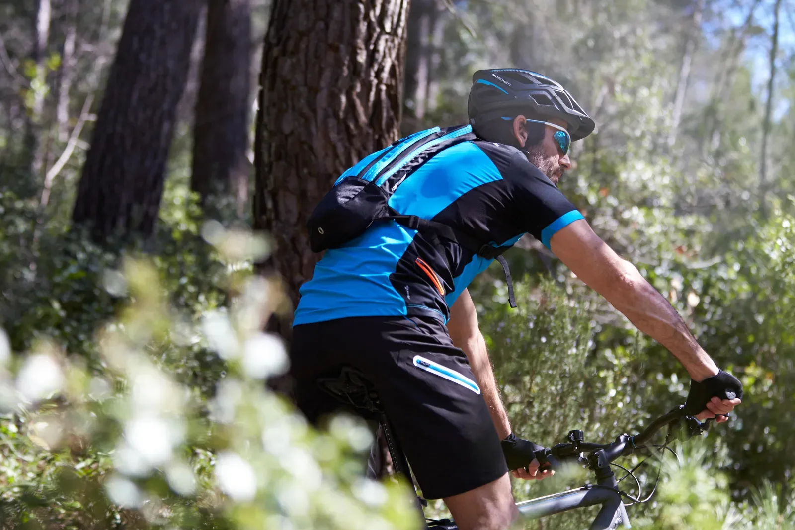 Mountain biker with gloves and a hydration pack on a trail