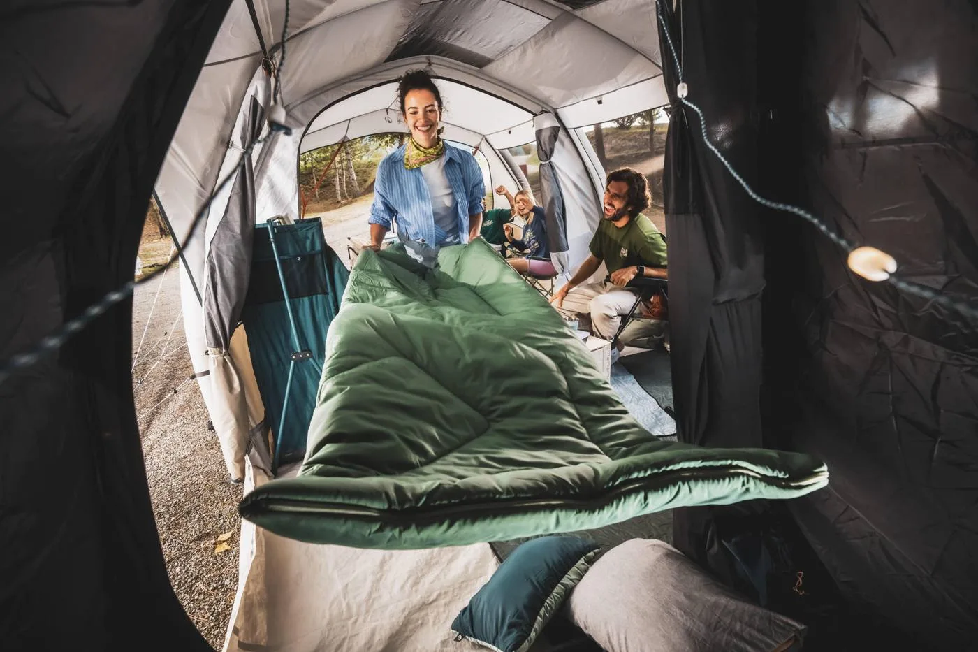 Camper settling into a sleeping bag inside a tent
