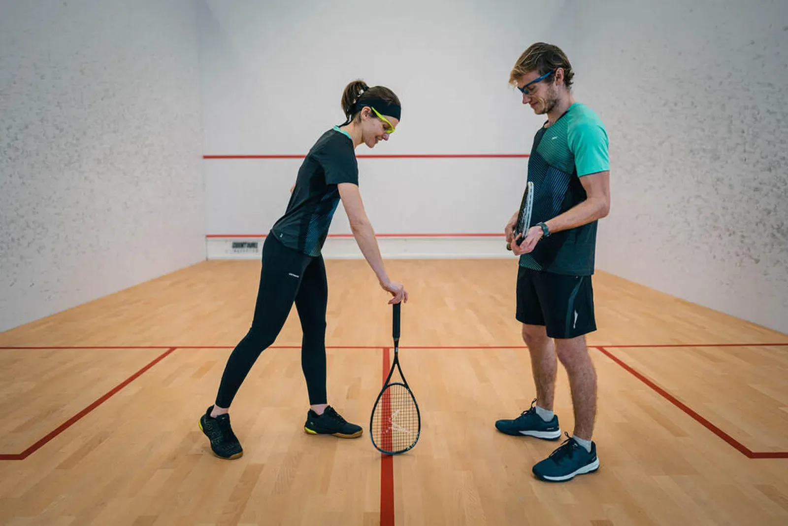 Two squash players chatting between rallies on court